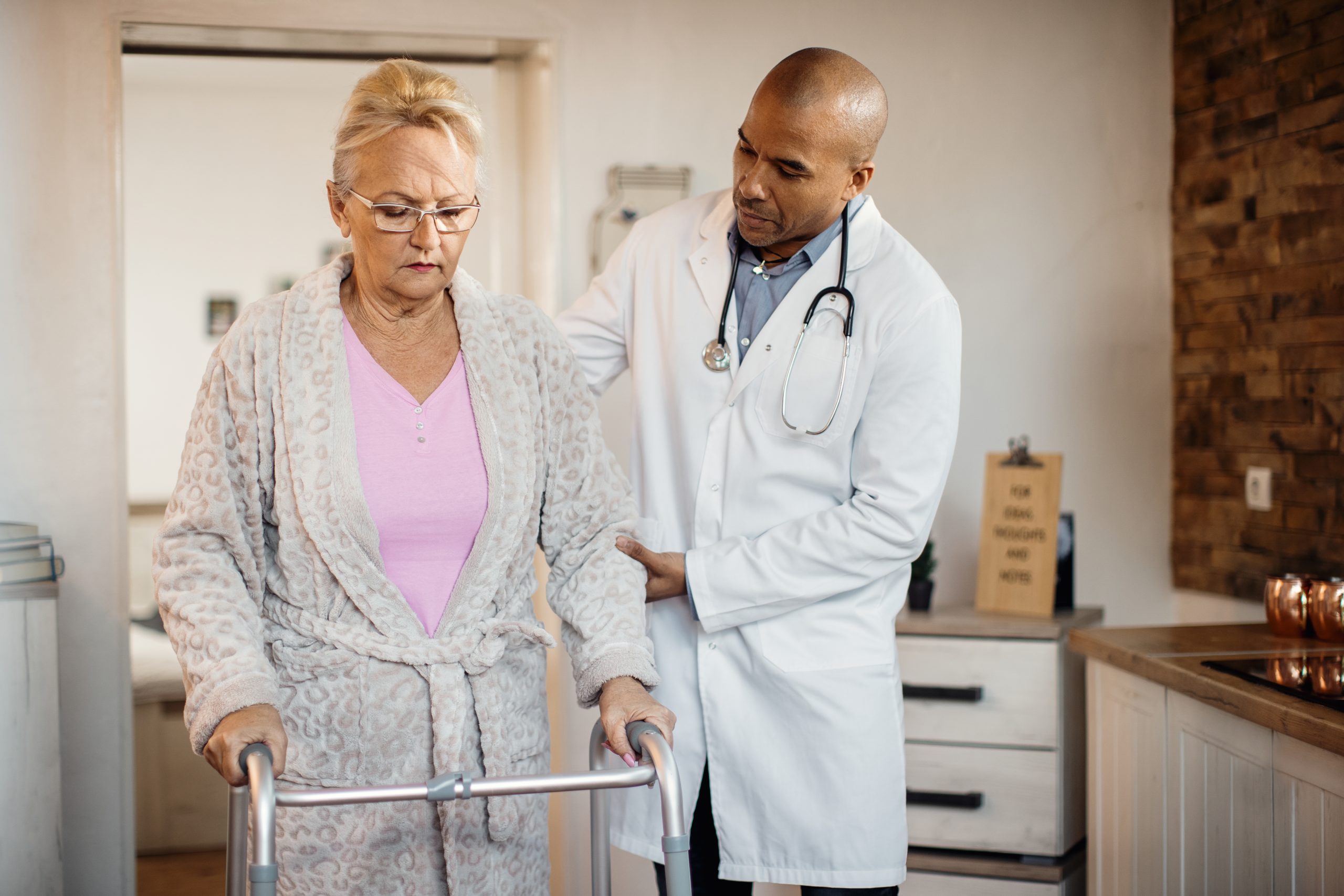 Healthcare professional supporting a patient with mobility