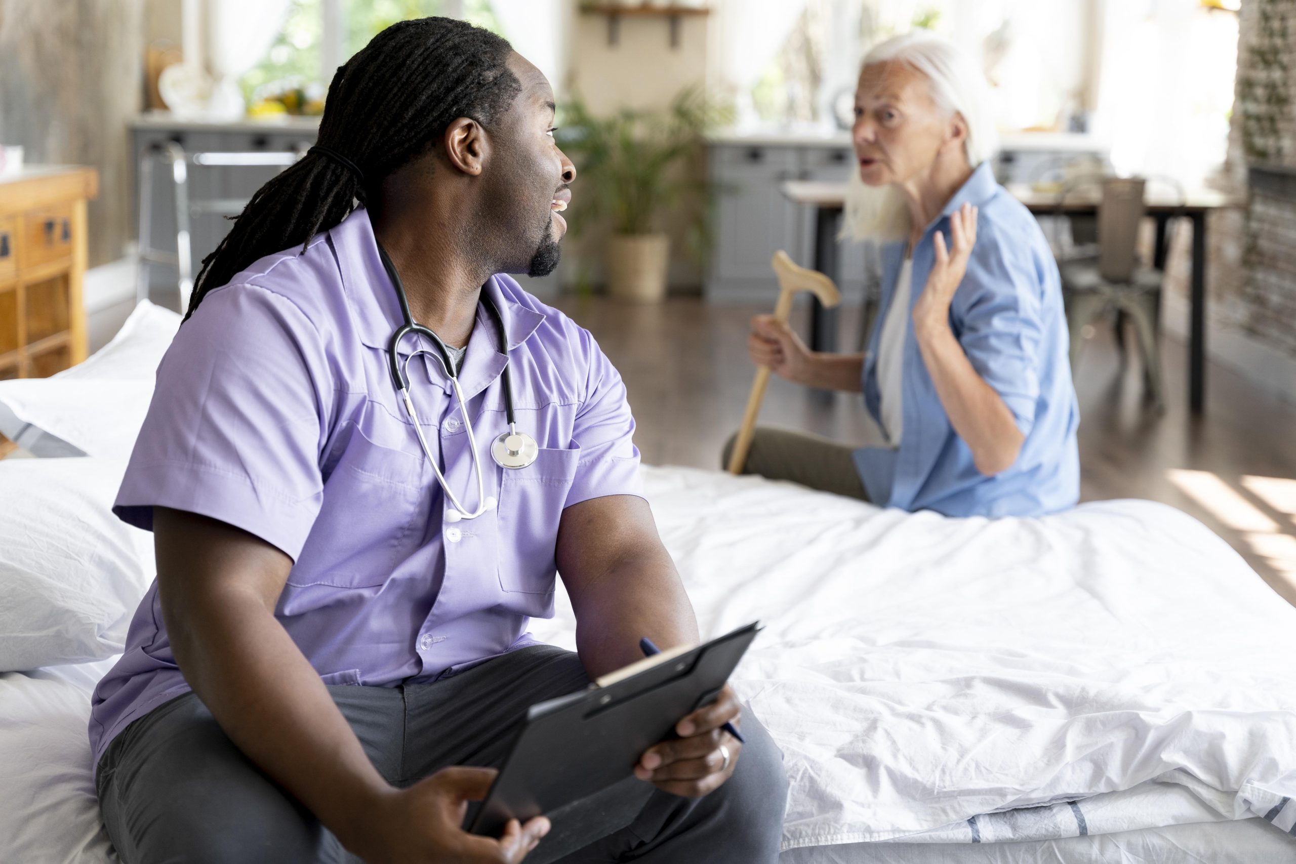 Care professional supporting a senior woman