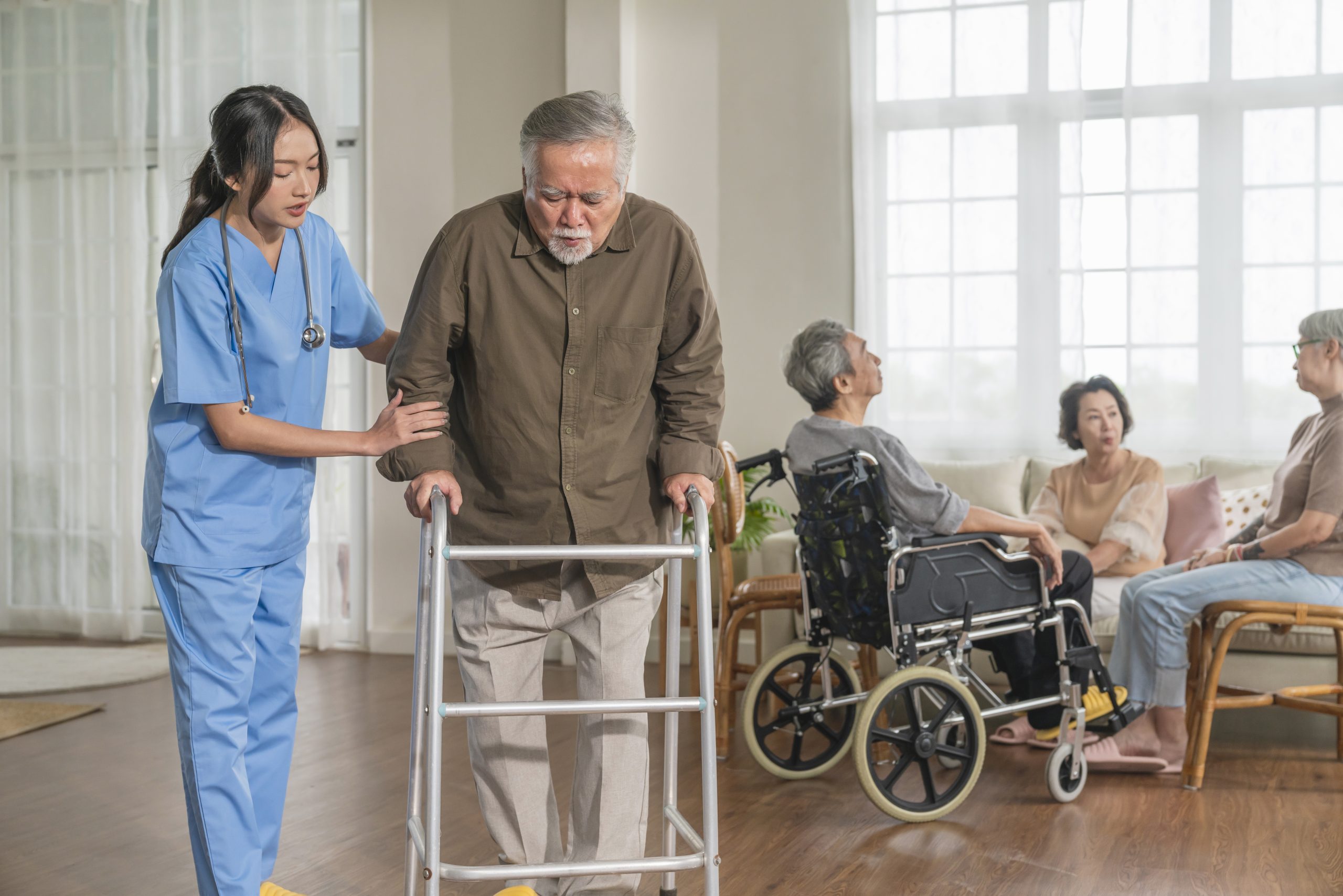 Healthcare professional helping a senior patient with mobility